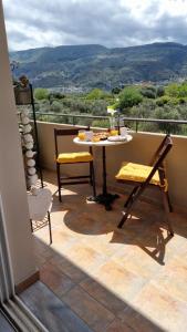 a table and chairs on a balcony with a view at Chania Homely Apartments in Souda