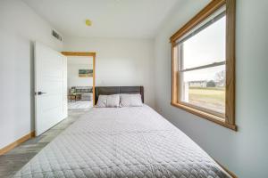 a bedroom with a bed and a window at Welcoming Erie Condo with Golf and Lake Views! in Erie