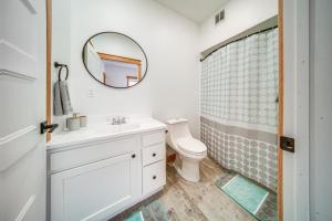 a bathroom with a white sink and a shower at Welcoming Erie Condo with Golf and Lake Views! in Erie