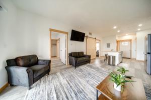 a living room with two couches and a table at Erie Vacation Rental with Patio, Near Golf Course! in Erie