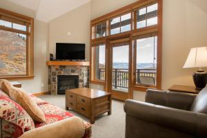 a living room with a couch and a fireplace at Capitol Peak Lodge - CoralTree Residence Collection in Snowmass Village