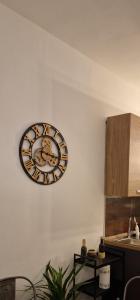 a clock hanging on a wall in a kitchen at Nico&Francy holiday in Iglesias