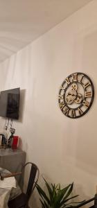 a clock is hanging on a wall at Nico&Francy holiday in Iglesias