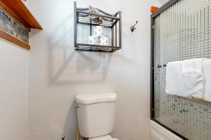 a white bathroom with a toilet and a shower at Little Slice of Heaven in Neskowin