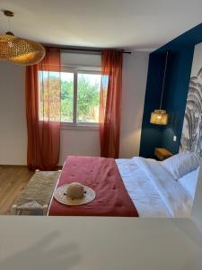 a bedroom with a bed with a hat on it at La poudrière in Figari