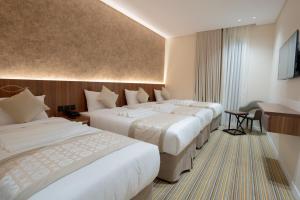 Postel nebo postele na pokoji v ubytování Rawha Al Maqam Ajyad Hotel + 37 fotografií