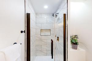 a bathroom with a shower with a glass door at A Peaceful Place in Kennesaw