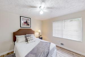 a bedroom with a bed and a ceiling fan at A Peaceful Place in Kennesaw