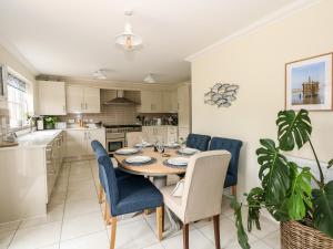 a dining room with a table and chairs in a kitchen at Coral House in Cromer