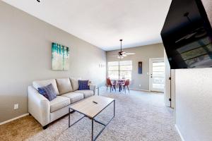 a living room with a couch and a table at The Greens at Ventana Canyon #1205 in Tucson