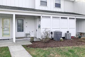 a white house with a white fence and a yard at Mallard Lakes --- 38287 Cardinal Ln Unit 134 in Selbyville