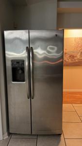 a stainless steel refrigerator with a water dispenser on it at Guest House In Cantonment in Jacksonville