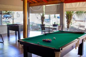 a pool table with balls on it in a room at Pousada Recanto Flor de Lótus in Olímpia