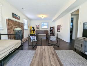 a living room with a bed and a fireplace at Spacious family friendly home with game room by UNC Charlotte in Charlotte