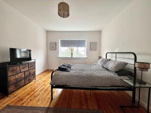 a bedroom with a bed and a television in it at Early Sunrise - Entire House in Withernsea in Withernsea