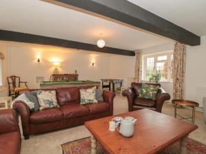 a living room with a couch and a table at The Stable House in Sherborne