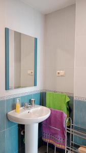 a bathroom with a sink and a mirror and a towel at GETAWAYS in Valdés