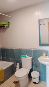 a bathroom with a toilet and a sink at GETAWAYS in Valdés +3 photos