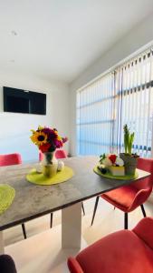 a dining room table with flowers on top of it at Shadwell - walking distance to Tower Bridge, two stations in close proximity in London