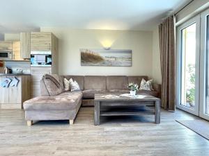a living room with a couch and a table at Haus Sterntaucher Appartement 4 in Thiessow