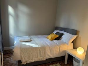 a bed with two pillows on it in a room at Flat In London's Primrose Hill in London