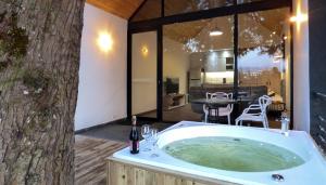 una bañera de hidromasaje frente a un árbol en Tree House, Cabaña privada con Jacuzzi, en Guatapé