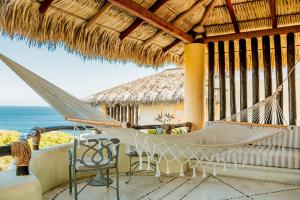 a hammock on a resort balcony with the ocean at Quinta Real Huatulco in Santa Cruz Huatulco +137 photos