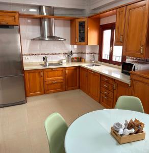 a kitchen with a white table and a counter top at La Viajera in Algarrobo