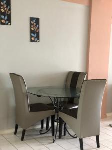 a glass table with two chairs around it at Pd Infront Seaview in Port Dickson