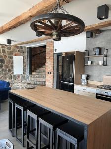 a kitchen with a large island with black bar stools at Rybacka Osada in Piecki