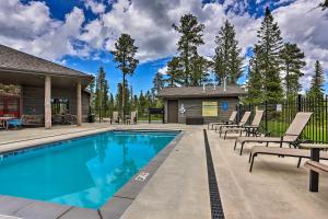 a swimming pool with lounge chairs and a house at Family-Friendly Lead Cabin with Loft and Balcony! in Lead