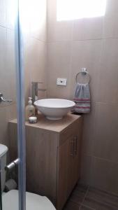 a bathroom with a white sink and a shower at Confort y descanso cerca al mar in Cartagena de Indias