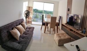 a living room with a couch and a table at Encantador apartamento con aire in Neiva