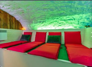 a room with red and green cushions on a boat at 6 bedrooms mansion with sauna enclosed garden and wifi at Aywaille in Aywaille