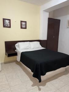 Postel nebo postele na pokoji v ubytování Hotel Cupules