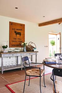 a dining room with a table and a table and chairs at The Carthouse in Ledbury