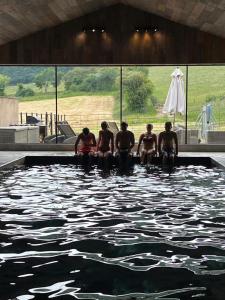 a group of people sitting in a swimming pool at The Carthouse in Ledbury