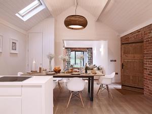 a kitchen and dining room with a table and chairs at The Piggery in Ledbury