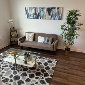 a living room with a couch and a rug at Luxury Condo with Pool & Gym ! in Glendale