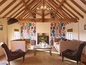 a living room with couches and a table at The Millhouse, South Courtyard in Ledbury