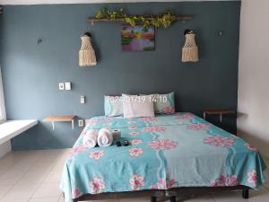 a bedroom with a bed with a blue wall at Villa Akbal with private pool in Bacalar