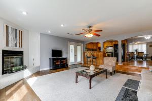 a living room with a couch and a fireplace at Peaceful Delco Family Home with Private Deck! 