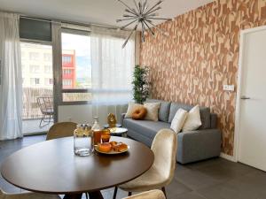 a living room with a table and a couch at Suite Helena in Villeurbanne