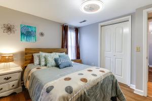 a bedroom with a bed and a white door at Peaceful Delco Family Home with Private Deck! 