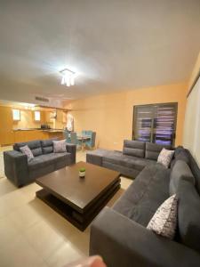 a living room with a couch and a coffee table at شقة مطلة على بركة سباحه in Al Burj