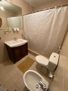 a bathroom with a toilet and a sink at شقة مطلة على بركة سباحه in Al Burj