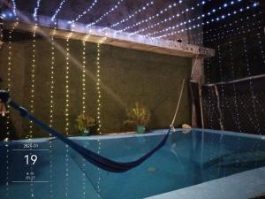 a swimming pool with a net and lights at Villa Akbal with private pool in Bacalar