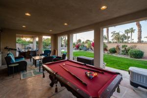 a pool table in the middle of a patio at Coachella Play - 6BR Multi-Gen Fun Zone and Retreat with free heated pool in Indio