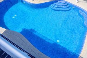 a swimming pool filled with blue water on a sidewalk at Sailors Beach Fiji in Nadi