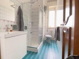 a white bathroom with a shower and a toilet at Casa Dolci Rodolfo large bright apartment 4km to Seaside in Montemarciano